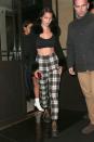 <p>In plaid pants, a black bralette, a Chrome Hearts x Bella cardigan and lace-up combat boots while out in London.</p>