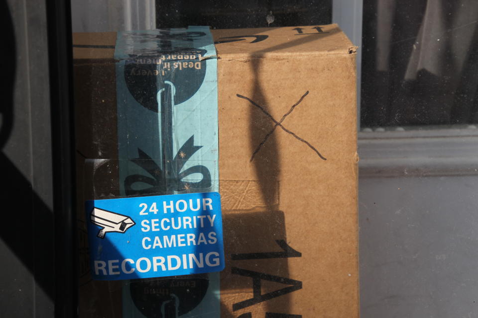 Baltimore resident Rosemarie Dumhart uses a decoy package, marked with an X, to discourage the so-called "porch pirates" operating in the Canton area of Baltimore, Maryland, on December 17, 2018. - The thieves are filmed by a camera located above the door. (Photo by Sébastien DUVAL / AFP)        (Photo credit should read SEBASTIEN DUVAL/AFP via Getty Images)