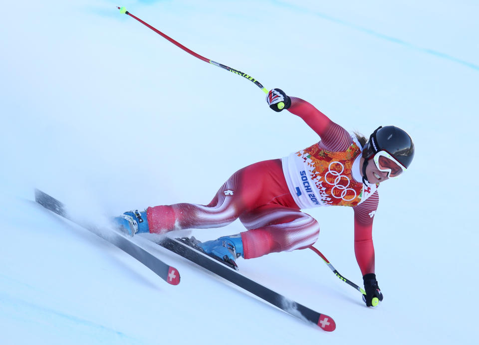 Switzerland's Fabienne Suter makes a turn in a women's downhill training run for the Sochi 2014 Winter Olympics, Friday, Feb. 7, 2014, in Krasnaya Polyana, Russia. (AP Photo/Alessandro Trovati)