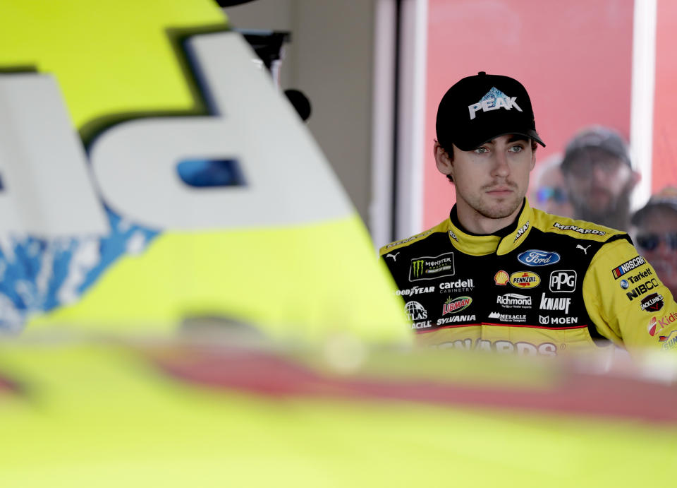 Ryan Blaney stands by his car as his crew makes adjustments during a practice session for the NASCAR Daytona 500 auto race at Daytona International Speedway, Friday, Feb. 16, 2018, in Daytona Beach, Fla. (AP Photo/John Raoux)