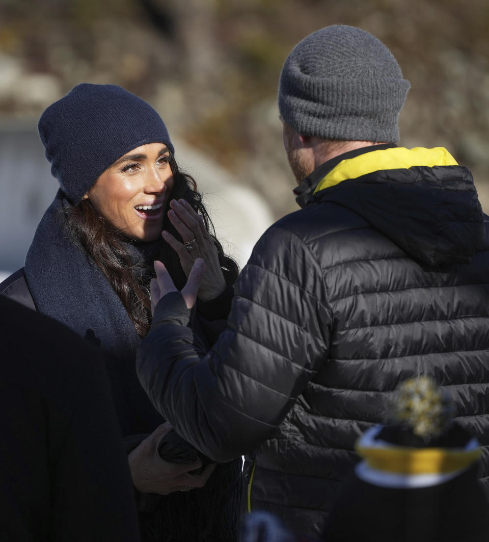 Meghan Markle, left, the Duchess of Sussex, reacts while listening to Prince Harry the Duke of Sussex, after he slid down the track on a skeleton sled during an Invictus Games training camp, in Whistler, British Columbia, Thursday, Feb. 15, 2024. Invictus Games Vancouver Whistler 2025 is scheduled to take place from Feb. 8 to 16, 2025 and will for the first time feature winter sports. (Darryl Dyck/The Canadian Press via AP)