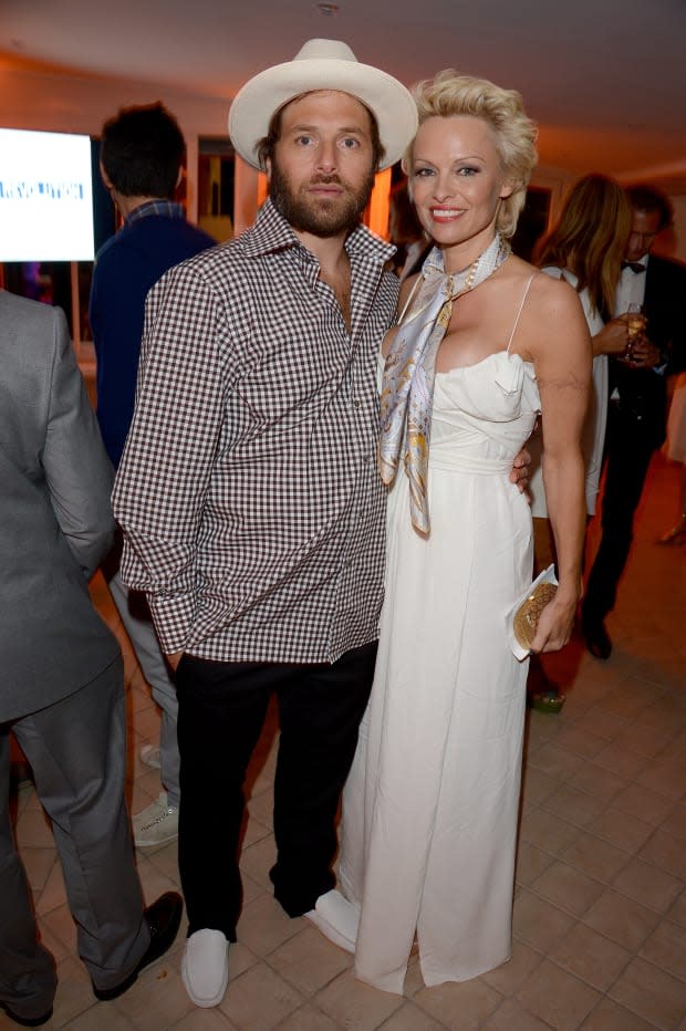 Pamela Anderson and Rick Salomon attend The Pamela Anderson Foundation launch co-hosted by Dame Vivienne Westwood in support of Cool Earth at the Cannes Film Festival on May 16, 2014.<p><a href="https://www.gettyimages.com/detail/491546145" rel="nofollow noopener" target="_blank" data-ylk="slk:David M. Benett/Getty Images;elm:context_link;itc:0;sec:content-canvas" class="link ">David M. Benett/Getty Images</a></p>