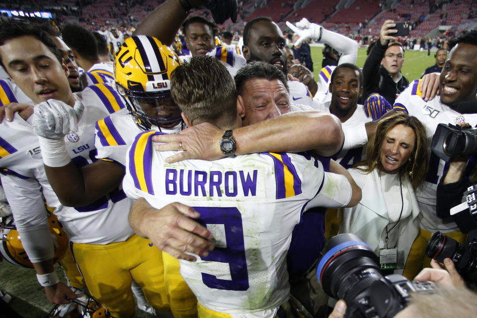 LSU head coach Ed Orgeron embraces quarterback Joe Burrow (9) after defeating Alabama 46-41 in an NCAA college football game, Saturday, Nov. 9, 2019, in Tuscaloosa, Ala. (AP Photo/John Bazemore)