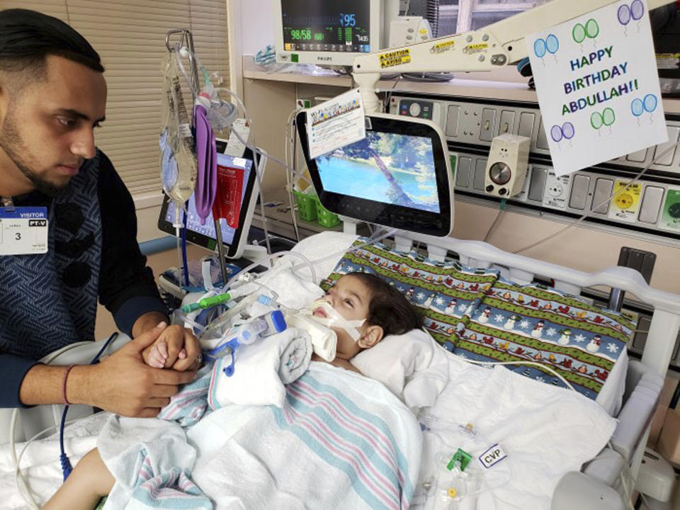 FILE - This recent undated photo, released Monday, Dec. 17, 2018, by the Council on American-Islamic Relations in Sacramento, Calif., shows Ali Hassan with his dying 2-year-old son Abdullah in a Sacramento hospital. Abdullah Hassan, the son of a Yemeni woman who sued the Trump administration to let her into the country to be with the ailing boy has died. The Council on American-Islamic Relations announced Friday, Dec. 28 that Abdullah died in an Oakland, Calif., hospital. He suffered from a genetic brain condition. (Council on American-Islamic Relations via AP, File)