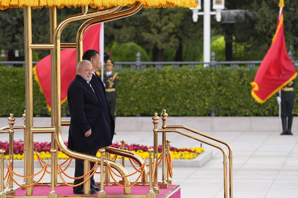Brazilian President Luiz Inacio Lula da Silva, left, inspects an honor guard with Chinese President Xi Jinping during a welcome ceremony held outside the Great Hall of the People in Beijing, China, Friday, April 14, 2023. (Ken Ishii/Pool Photo via AP)