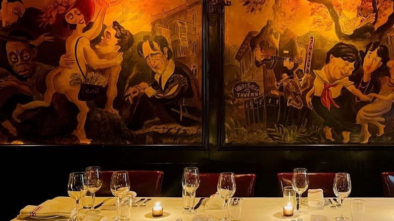 The dining room and murals at the Waverly Inn
