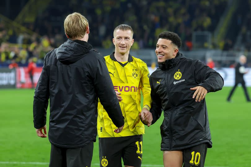 Marco Reus and Jadon Sancho celebrate reaching the quarter-finals of the Champions League with Borussia Dortmund.