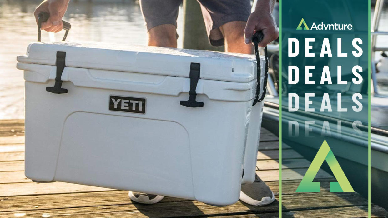  Man carrying Yeti Tundra cooler 