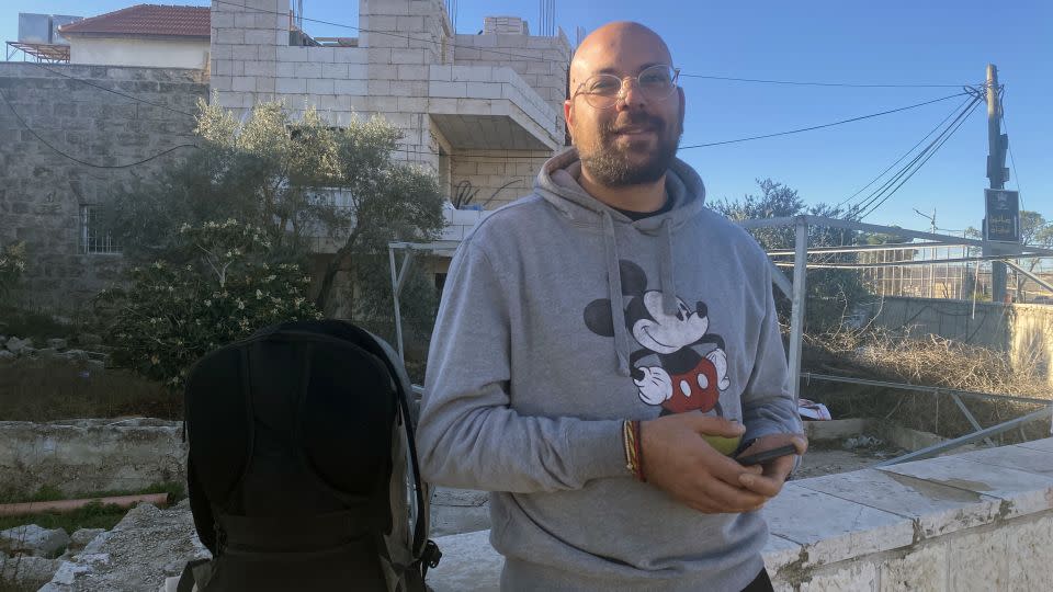 Joseph Handal waits on the road out of Bethlehem to see if an Israeli checkpoint will open on Monday, November 6. - Ivana Kottasova/CNN