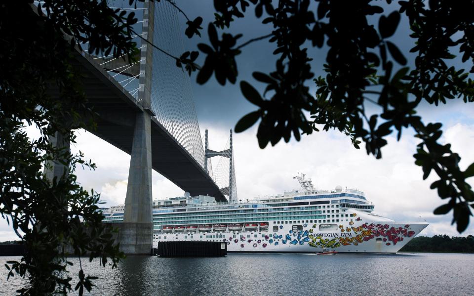 The Norwegian Cruise Line Ship Norwegian Gem heads west down the St. Johns River as it passes under the Dames Point Bridge on Wednesday, May 27, 2020.