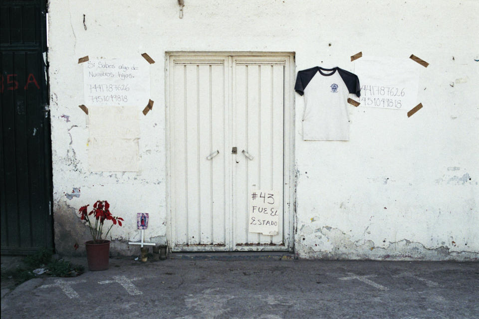Site of the attacks in the city of Iguala, Guerrero. Crosses on the ground mark where two Ayotzinapa students were shot. Parents of the missing students have posted phone numbers to call "if you know anything about our sons." Feb. 13, 2015.