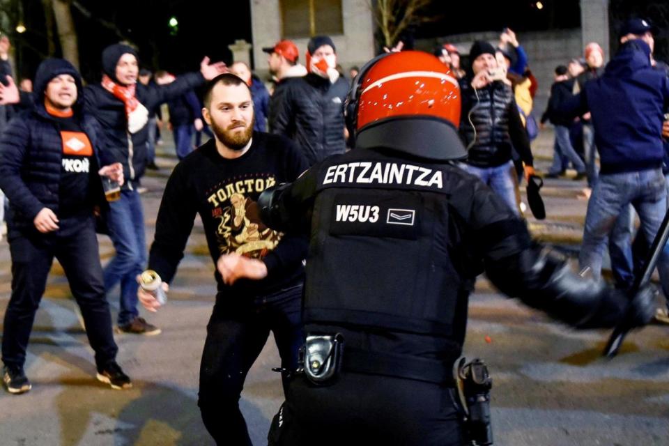 Police officers clash with supporters during riots prior to the Europa League match (EPA)