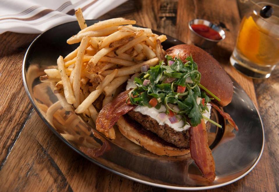 The Fresno Fig Burger is a signature entree available at all Eureka! restaurants. It features an Angus beef patty, bacon, fig marmalade, goat cheese, arugula and a spicy porter mustard.