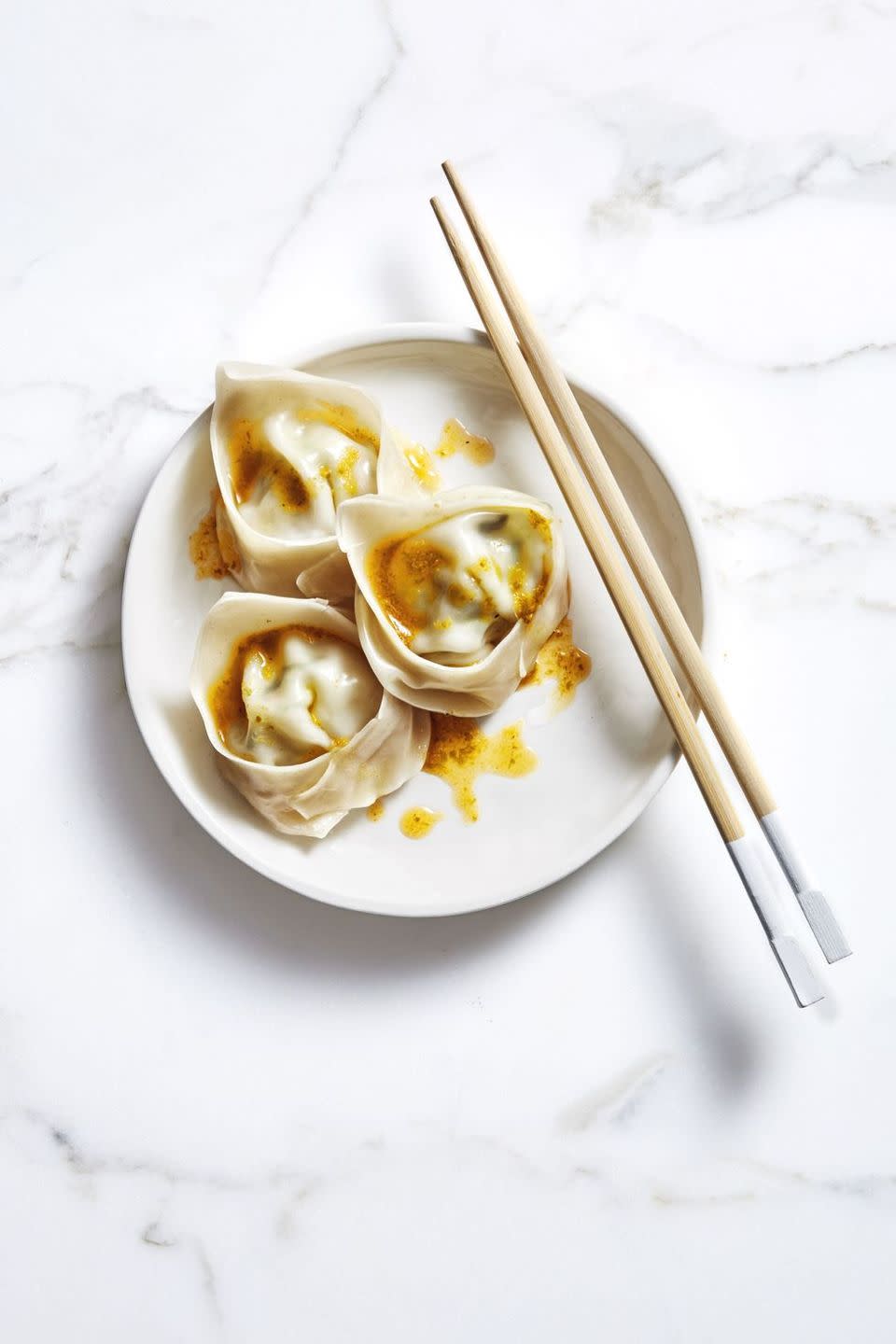 <p>These classic wontons are just as fun to make as they are to eat. Serve with spicy chili oil to bring the heat!</p><p>Get the <a href="https://www.goodhousekeeping.com/food-recipes/a47683/gingery-pork-and-chive-wontons-recipe/" rel="nofollow noopener" target="_blank" data-ylk="slk:Gingery Pork and Chive Wontons recipe;elm:context_link;itc:0;sec:content-canvas" class="link "><strong>Gingery Pork and Chive Wontons recipe</strong></a>. </p>