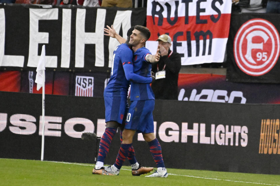 United States' Christian Pulisic, right, celebrates his goal with teammate Tim Weah during an international friendly soccer match against Germany at Pratt & Whitney Stadium at Rentschler Field, Saturday, Oct. 14, 2023, in East Hartford, Conn. (AP Photo/Jessica Hill)