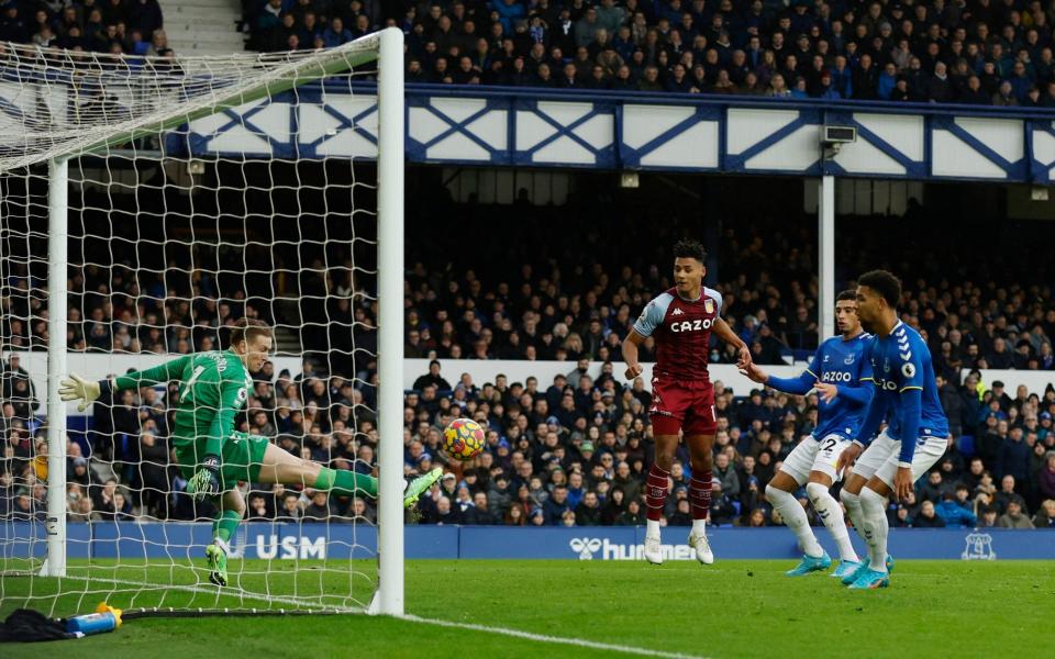 Premier League - Everton v Aston Villa - Goodison Park, Liverpool, Britain - January 22, 2022 Aston Villa's Ollie Watkins heads at goal as Everton's Jordan Pickford - Action Images