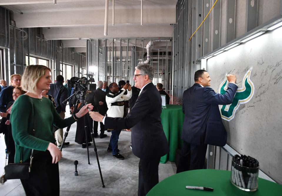 Guests sign an interior wall of the new student center and residence hall on the campus of the University of South Florida Sarasota-Manatee during a construction celebration on Monday, Jan. 22, 2024.