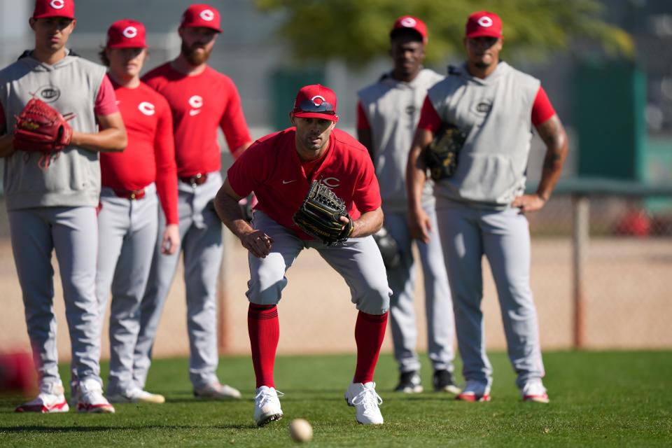 Pitcher Nick Martinez participates in fielding drills. The Reds are stressing details like base running, defense and fundamentals in camp.