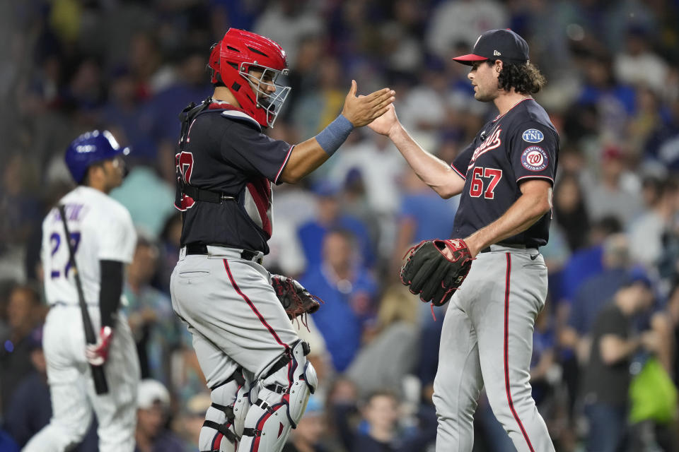 Washington Nationals relief pitcher Kyle Finnegan (67) celebrates with catcher Keibert Ruiz after Finnegan struck out Chicago Cubs' Seiya Suzuki, left, in a baseball game Monday, July 17, 2023, in Chicago. The Nationals won 7-5. (AP Photo/Charles Rex Arbogast)