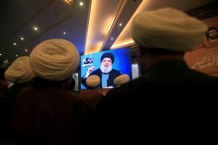 Lebanon's Hezbollah leader Sayyed Hassan Nasrallah addresses his supporters through a screen during a rally commemorating the annual Hezbollah Martyrs' Leaders Day in Jebshit village, southern Lebanon February 16, 2017. REUTERS/Ali Hashisho