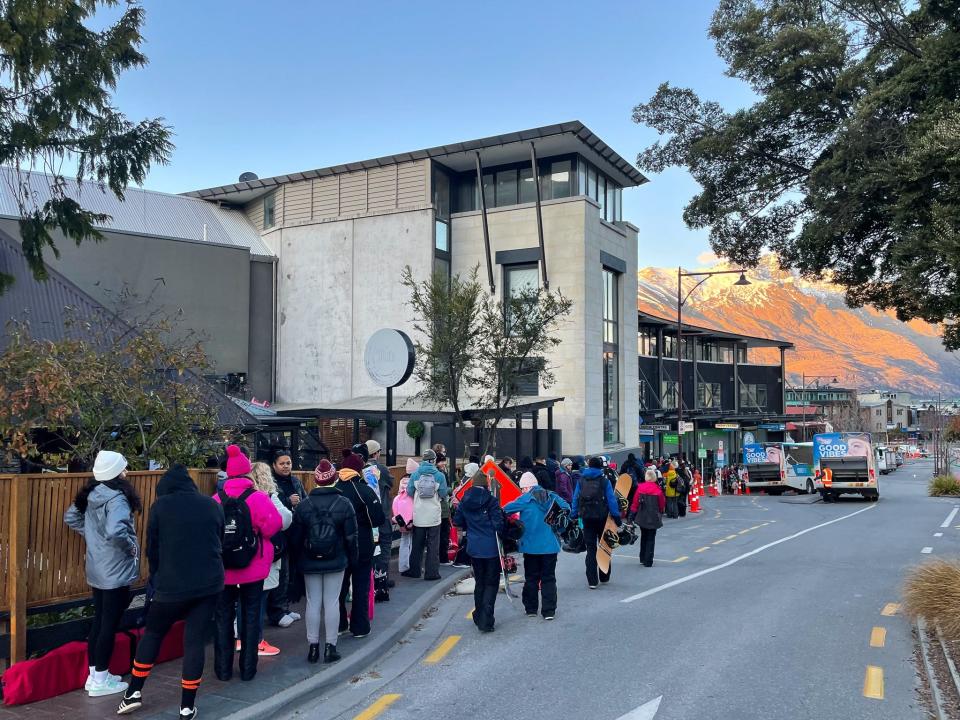 Skiers line up for a shuttle to the slopes in Queenstown, New Zealand.