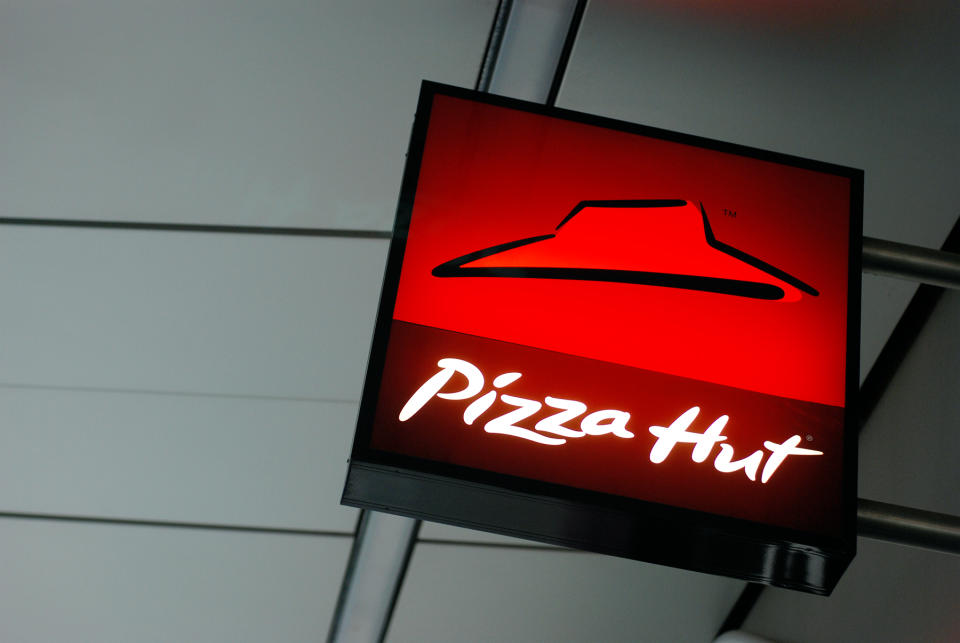 Liverpool, England - February 27, 2011: Sign of Pizza Hut in Liverpool One shopping center. Pizza Hut  is an American restaurant chain and international franchise that offers different styles of pizza along with side dishes including pasta, buffalo wings, breadsticks, and garlic bread.