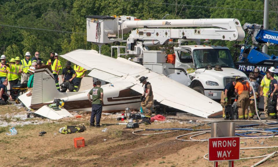 Emergency crews respond to a plane that crashed into a bucket truck just west of the toll plaza on the Pennsylvania Turnpike near I-83 May 31, 2023.