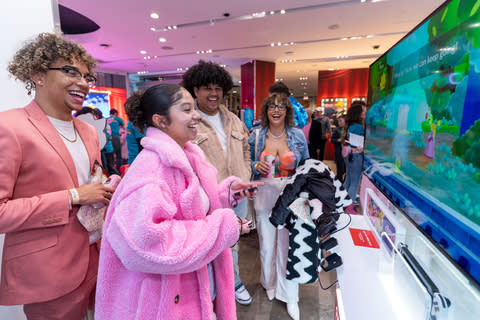 In this photo provided by Nintendo of America, a fan plays Princess Peach: Showtime while playing Princess Peach's own game in the spotlight. At the Nintendo New York Store in Rockefeller Center!