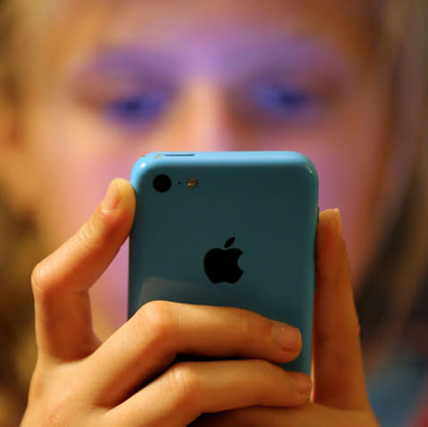 A teenage girl using an iphone mobile phone - Credit: Chris Radburn/PA