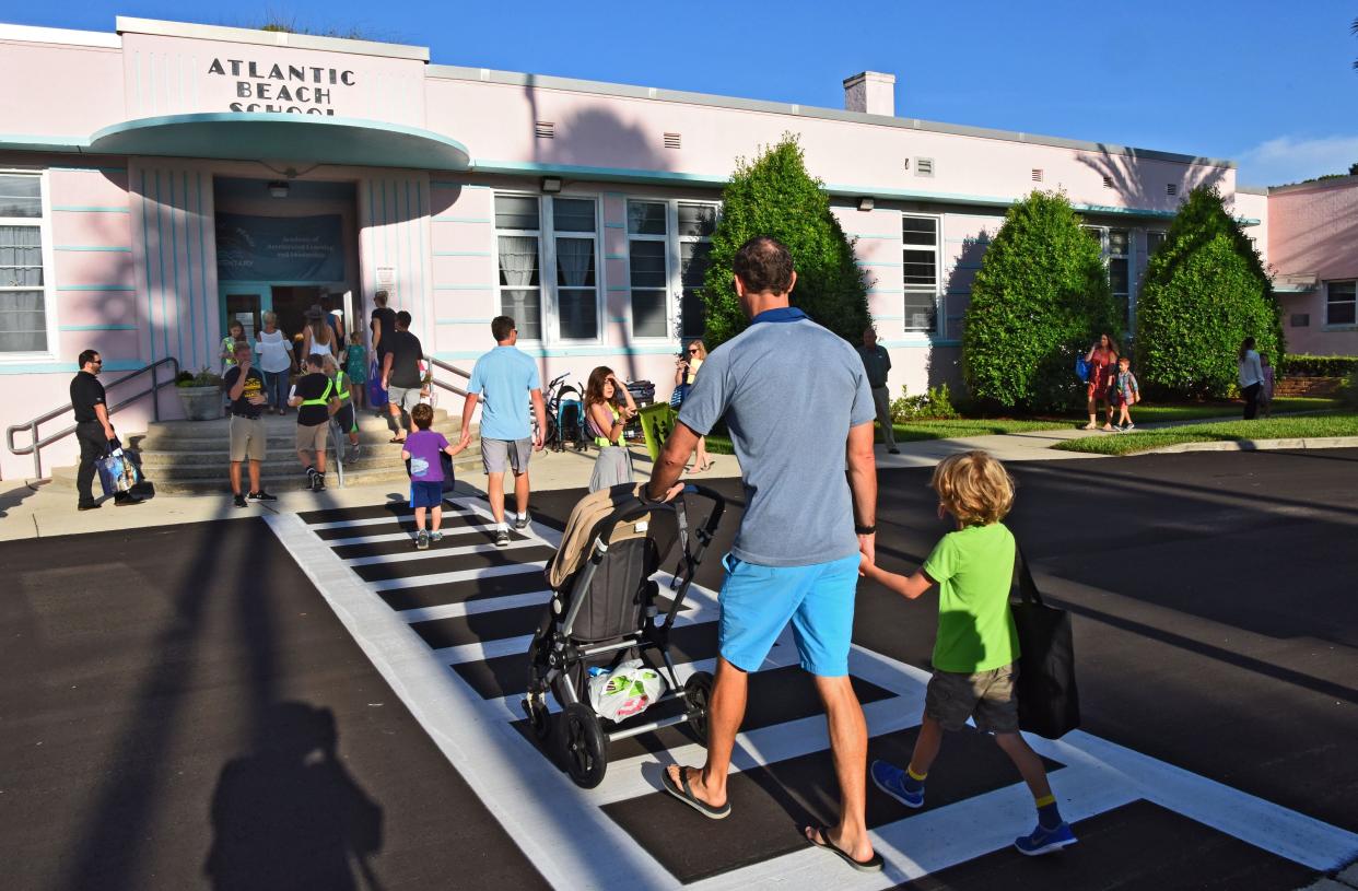 In this 2017 photo, children line up in a crosswalk to reach Atlantic Beach Elementary. The school is one of dozens that Duval County school officials have weighed closing as they struggled this spring to manage ballooning costs for school facilities.