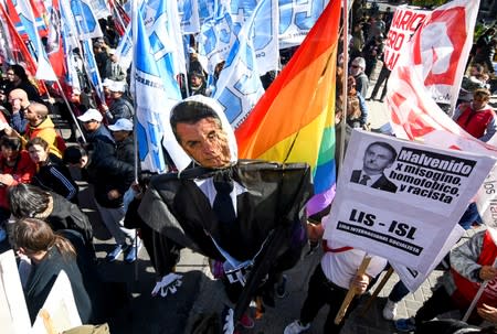 Demonstrators hold a puppet depicting Brazil's President, Jair Bolsonaro, during a protest outside the 54th Summit of Heads of State of Mercosur and Associated States, in Santa Fe