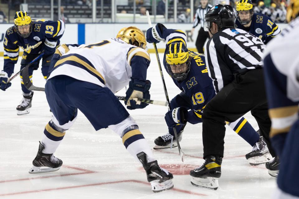 Michigan forward Adam Fantilli (19) and Notre Dame forward Jackson Pierson (11) set to face-off during the Michigan-Notre Dame NCAA hockey game on Saturday, November 12, 2022, at Compton Family Ice Arena in South Bend, Indiana.