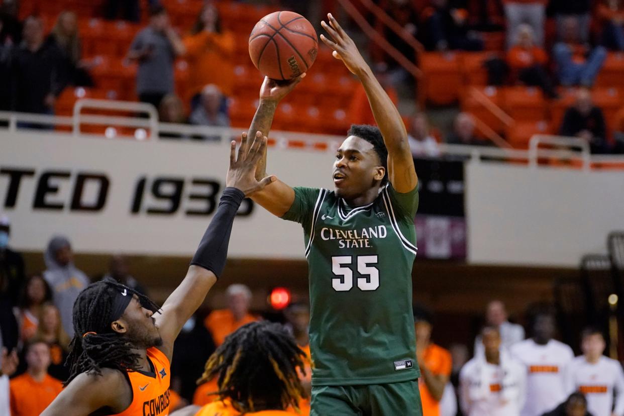 Cleveland State guard D'Moi Hodge (55) shoots over Oklahoma State guard Isaac Likekele, left, in overtime of a game Dec. 13, 2021, in Stillwater, Okla.