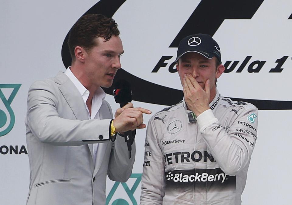 British actor Cumberbatch interviews second-placed Mercedes Formula One driver Rosberg on the podium after the Malaysian F1 Grand Prix at Sepang International Circuit outside Kuala Lumpur