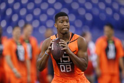 FILE - In this Feb. 21, 2015, file photo, Florida State quarterback Jameis Winston runs a drill at the NFL football scouting combine in Indianapolis. While 26 draft-eligible players have accepted invitations from the NFL to attend the proceedings later this month, Winston and Marcus Mariota are not among them. The two most recent Heisman Trophy winners and highest-profile players in this year&#39;s crop have opted to stay home with their families for the April 30-May 2 draft. (AP Photo/Julio Cortez, File)