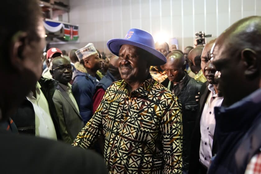 Kenyan presidential candidate Raila Odinga, center, walks through the crowd during departure after delivering an address to the nation at his campaign headquarters in downtown Nairobi, Kenya, Tuesday, Aug. 16, 2022. Kenya is calm a day after Deputy President William Ruto was declared the winner of the narrow presidential election over longtime opposition figure Raila Odinga. (AP Photo/Ben Curtis)