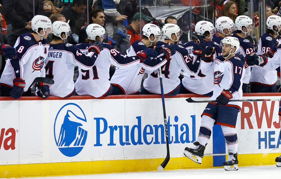 Columbus Blue Jackets right wing Justin Danforth (17) celebrates with teammates after scoring a goal against the New Jersey Devils during the second period of an NHL hockey game Wednesday Dec. 27, 2023, in Newark, N.J. (AP Photo/Noah K. Murray)