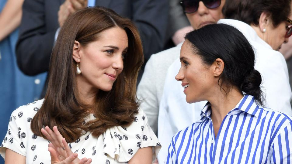 Catherine, Duchess of Cambridge and Meghan, Duchess of Sussex attend day twelve of the Wimbledon Tennis Championships at the All England Lawn Tennis and Croquet Club on July 14, 2018 in London, England. 