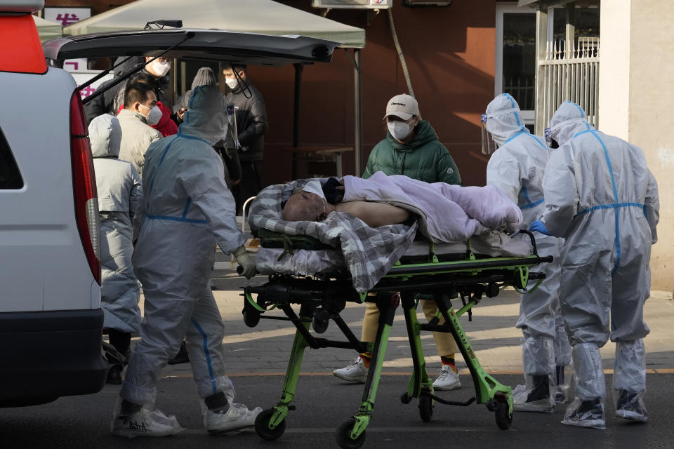 FILE - An elderly man on a stretcher is wheeled into the fever clinic at a hospital in Beijing, Dec. 9, 2022. China's sudden reopening after two years holding to a "zero-COVID" strategy left older people vulnerable and hospitals and pharmacies unprepared during the season when the virus spreads most easily, leading to many avoidable deaths, The Associated Press has found. (AP Photo/Ng Han Guan, File)