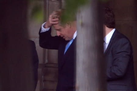 PM hopeful Boris Johnson walks near the Parliament grounds in London