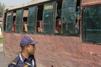 Rohingya refugees arrive at the Chittagong boat club to board naval vessels that will take them to Bhasan Char island, in Chittagong, Bangladesh, Thursday, Nov. 25, 2012. Thousands have been relocated on the island in the Bay of Bengal from crammed camps near the Myanmar border. (AP Photo)