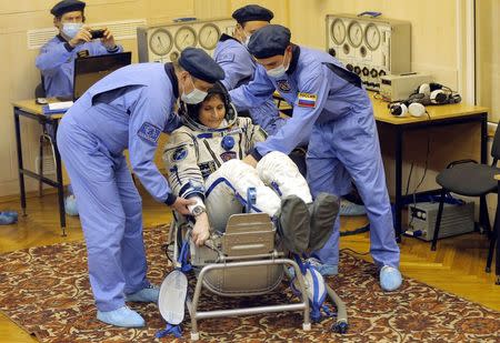 International Space Station (ISS) crew Samantha Cristoforetti of Italy tests her space suit during pre-launch preparations at the Baikonur cosmodrome November 23, 2014. REUTERS/Maxim Shipenkov/Pool