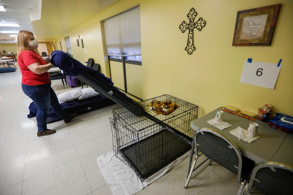 Emily Bowen-Marler, associate minister at Brentwood Christian Church, prepares the church's cold-weather shelter for unsheltered couples and their pets by putting sheets on air mattresses on Wednesday, Feb. 10, 2021.