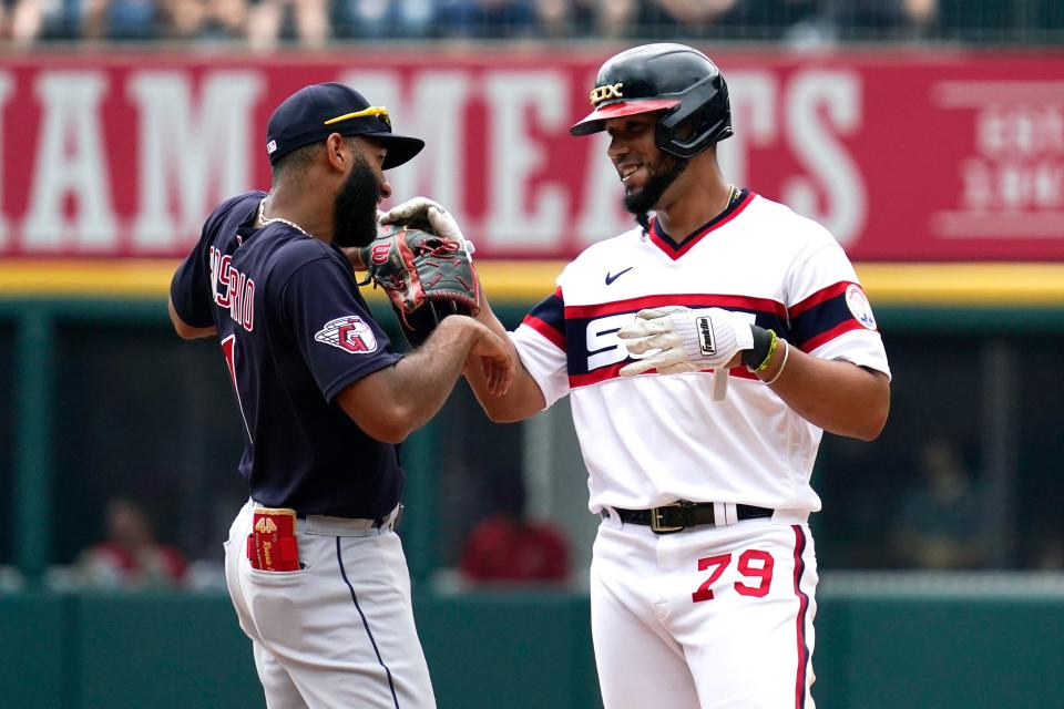 Chicago White Sox's Jose Abreu, right, talks with Cleveland Guardians shortstop Amed Rosario after hitting a double during the first inning of a baseball game in Chicago, Sunday, July 24, 2022. (AP Photo/Nam Y. Huh)