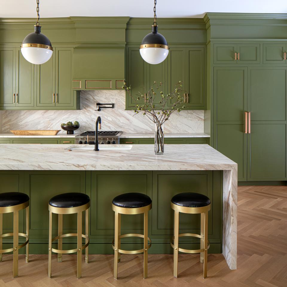 A leak led to an unplanned kitchen renovation. Floors were refinished in Rubio, which gave the wood a contemporary matte finish. Lindsay originally wanted to paint the cabinets oxblood red, but after happening across Farrow & Ball's Bancha green, she changed her plans. “I immediately felt like that was the right color, and it just brought nature in,” she says. The leather and brass stools are by Noir.