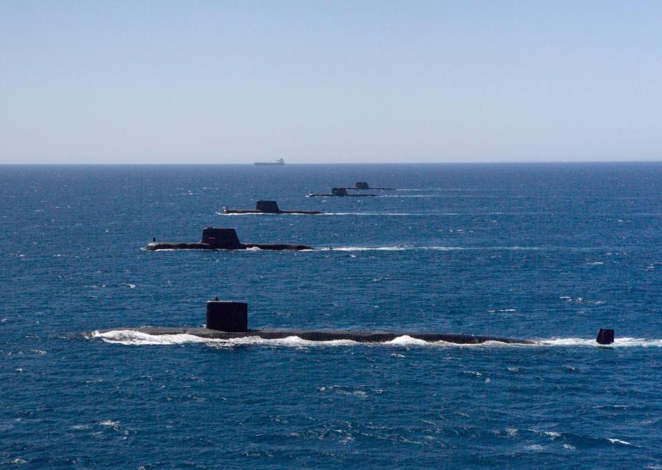 The <em>Los Angeles</em> class submarine USS <em>Santa Fe</em> transits in formation on the surface with Royal Australian Navy <em>Collins</em> class submarines HMAS <em>Collins</em>, HMAS <em>Farncomb</em>, HMAS <em>Dechaineux</em>, and HMAS <em>Sheean</em> in the West Australian Exercise Area, in February 2019. <em>Australian Department of Defense</em>