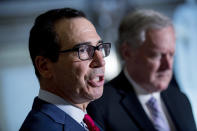Treasury Secretary Steven Mnuchin, left, accompanied by White House Chief of Staff Mark Meadows, right, speak to reporters following a meeting with House Speaker Nancy Pelosi of Calif. and Senate Minority Leader Sen. Chuck Schumer of N.Y. as they continue to negotiate a coronavirus relief package on Capitol Hill in Washington, Friday, Aug. 7, 2020. (AP Photo/Andrew Harnik)