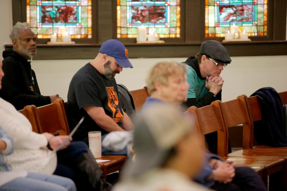People bow their heads in prayer at the 2023 Homeless Persons Memorial at Eighth Street Church of the Nazarene in Oklahoma City.