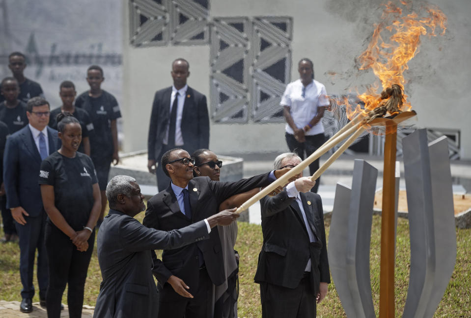 From left to right, Chairperson of the African Union Commission Moussa Faki Mahamat, Rwanda's President Paul Kagame, Rwanda's First Lady Jeannette Kagame, and President of the European Commission Jean-Claude Juncker, light the flame of remembrance at the Kigali Genocide Memorial in Kigali, Rwanda Sunday, April 7, 2019. Rwanda is commemorating the 25th anniversary of when the country descended into an orgy of violence in which some 800,000 Tutsis and moderate Hutus were massacred by the majority Hutu population over a 100-day period in what was the worst genocide in recent history. (AP Photo/Ben Curtis)