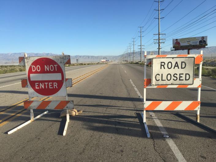 Signs blocked Gene Autry Trail in Palm Springs in 2019 as sand was blown across the road, reducing visibility.